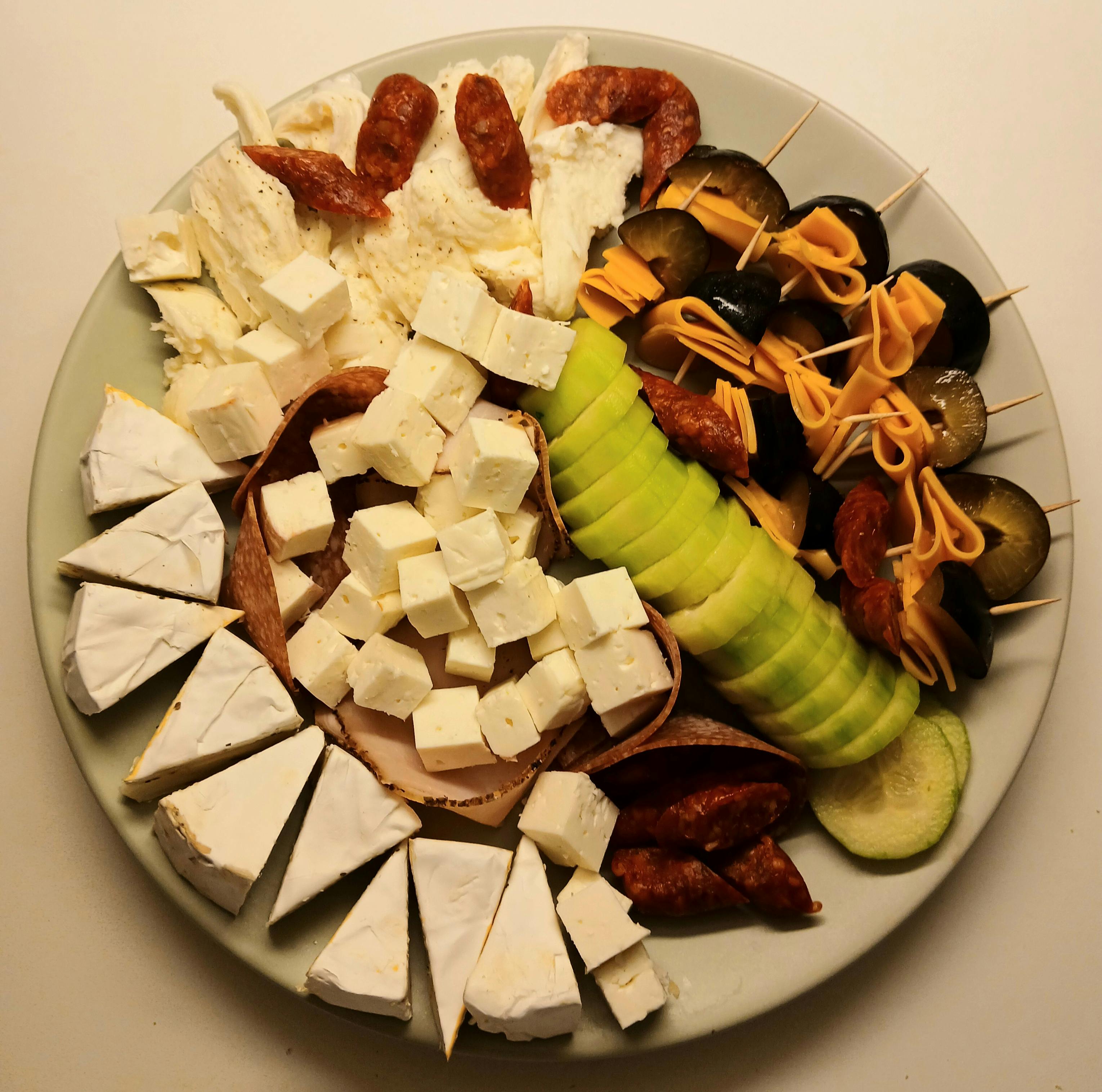 Prepared cheese tray with cheese and cucumbers